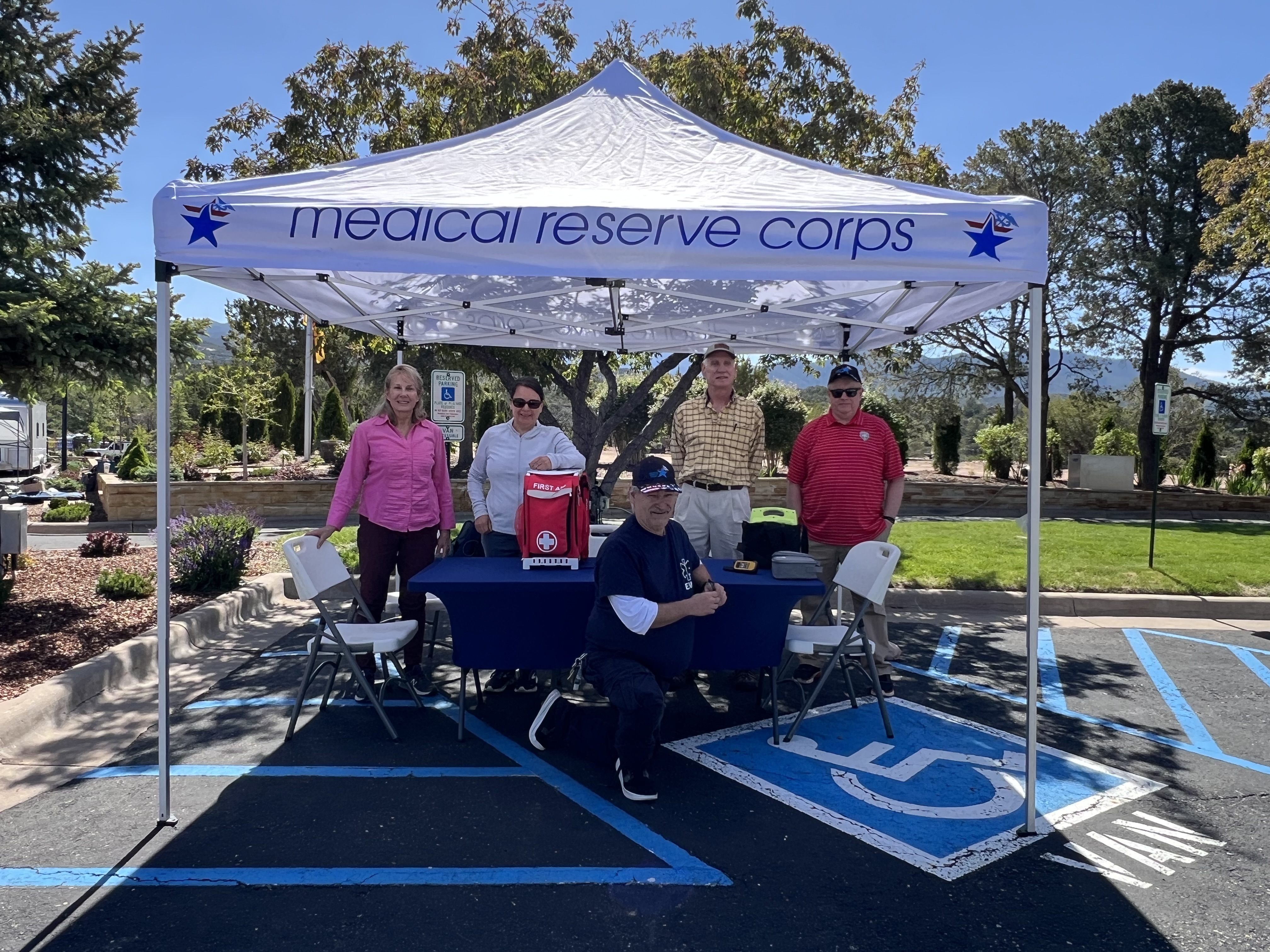 Photo of MRC Tent and volunteers at event.